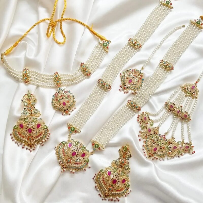 Our Gold Plated Nauratan Studded Complete Bridal Set is perfect for brides who want to have an exquisite royal look on their big day