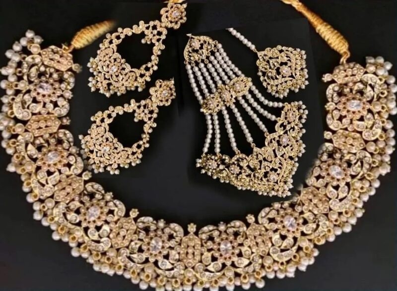 Our 22kt Gold Plated Necklace Set with Delicate Zircons and Pearl work is a perfect choice for brides to wear on their nikkah